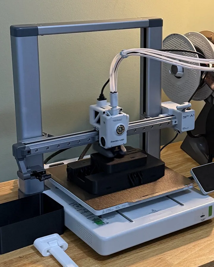 Our Bambu Lab A1 printing a black robot head shell